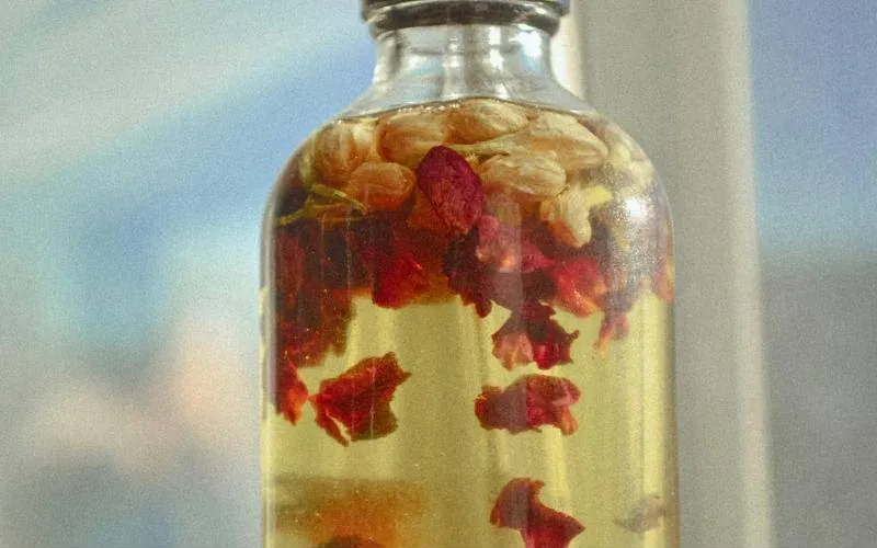 Massage oil with jasmine and rose petals